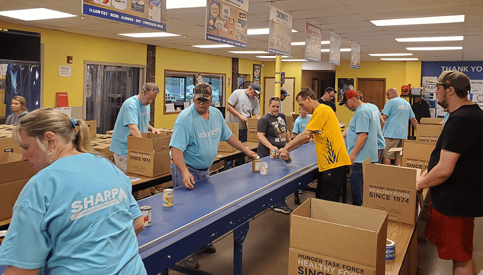 team helping pack canned food